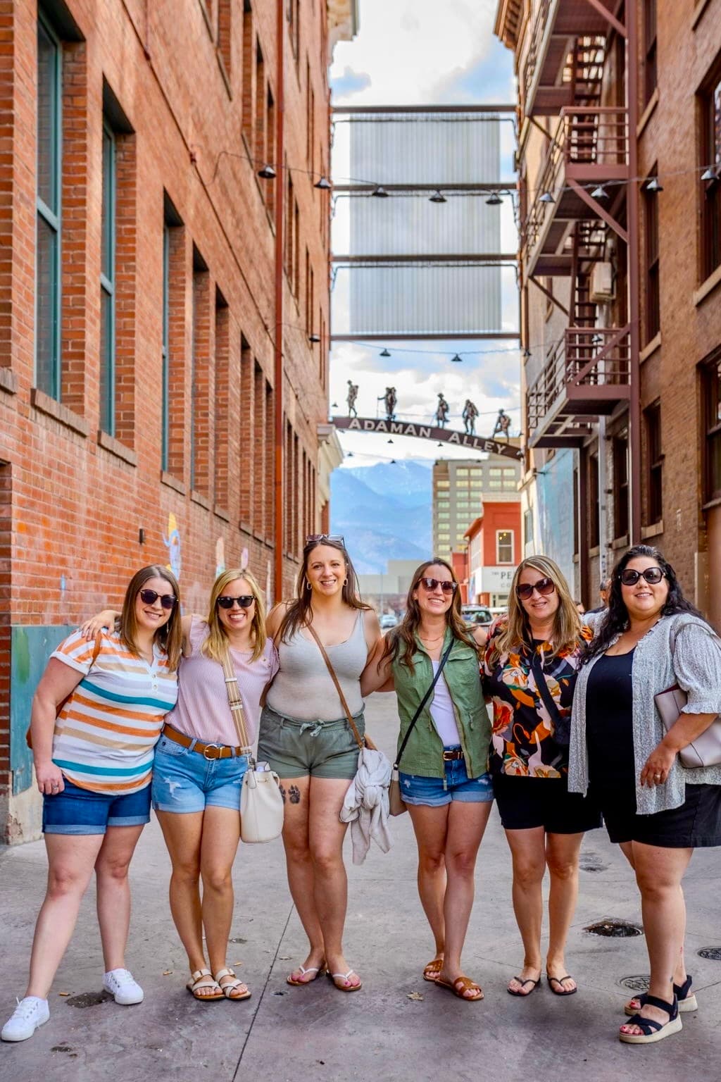 Bachelorette friends laughing during a downtown Colorado Springs food tour