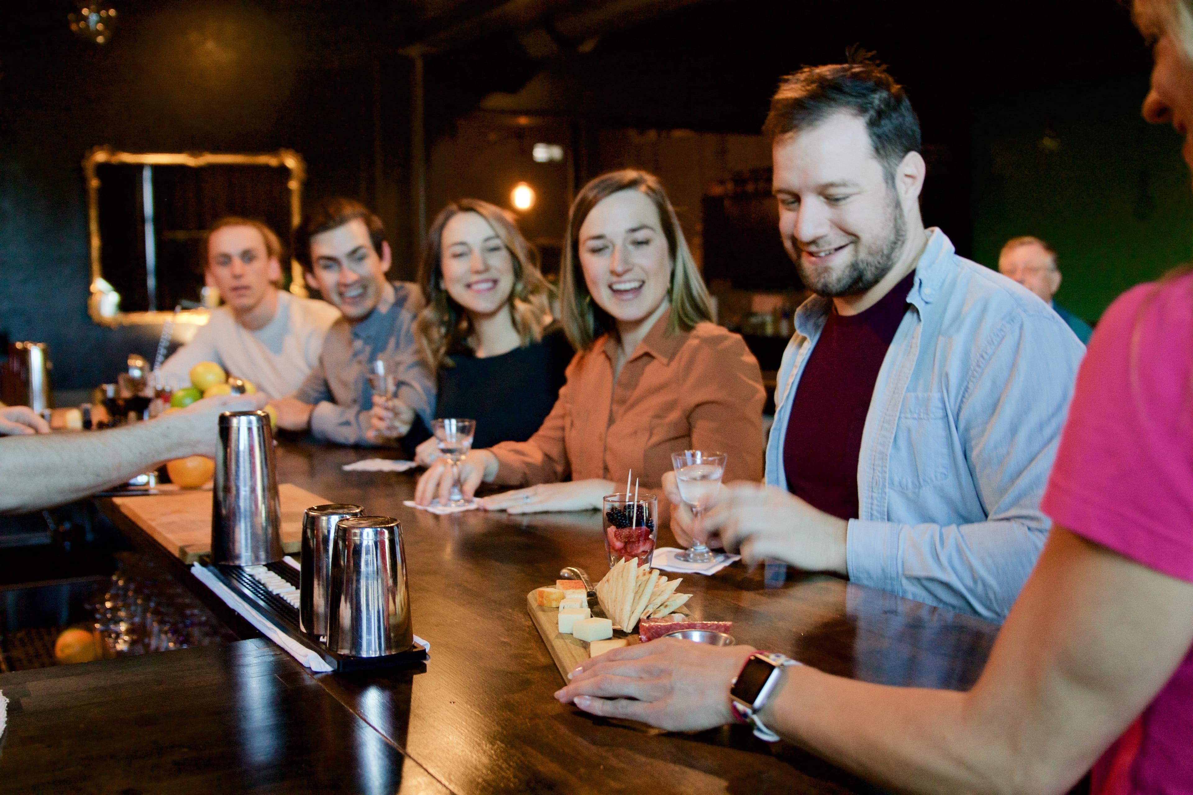 corporate group enjoying cocktails and charcuterie on a Rocky Mountain Food Tour