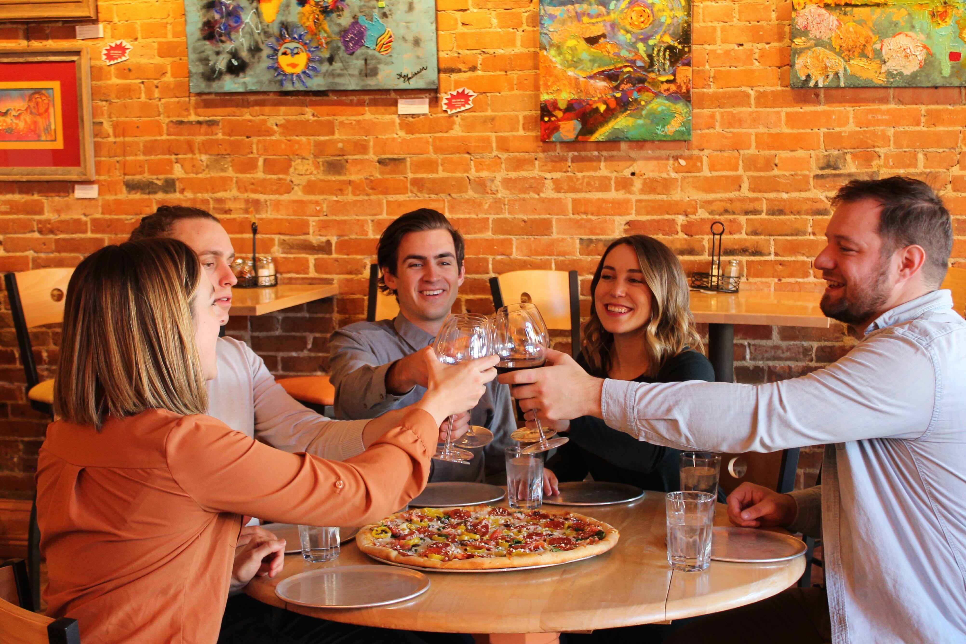 Friends toasting drinks on a Rocky Mountain Food Tour in Colorado Springs