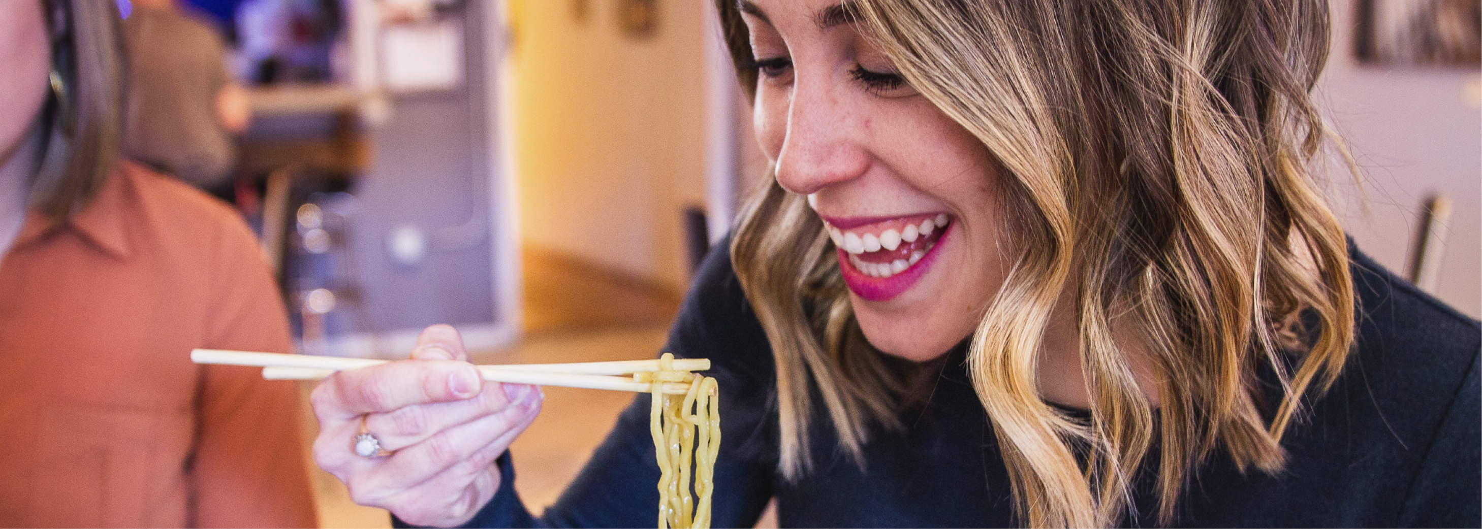 Woman Eating Ramen at Roosters House of Ramen in Colorado Springs