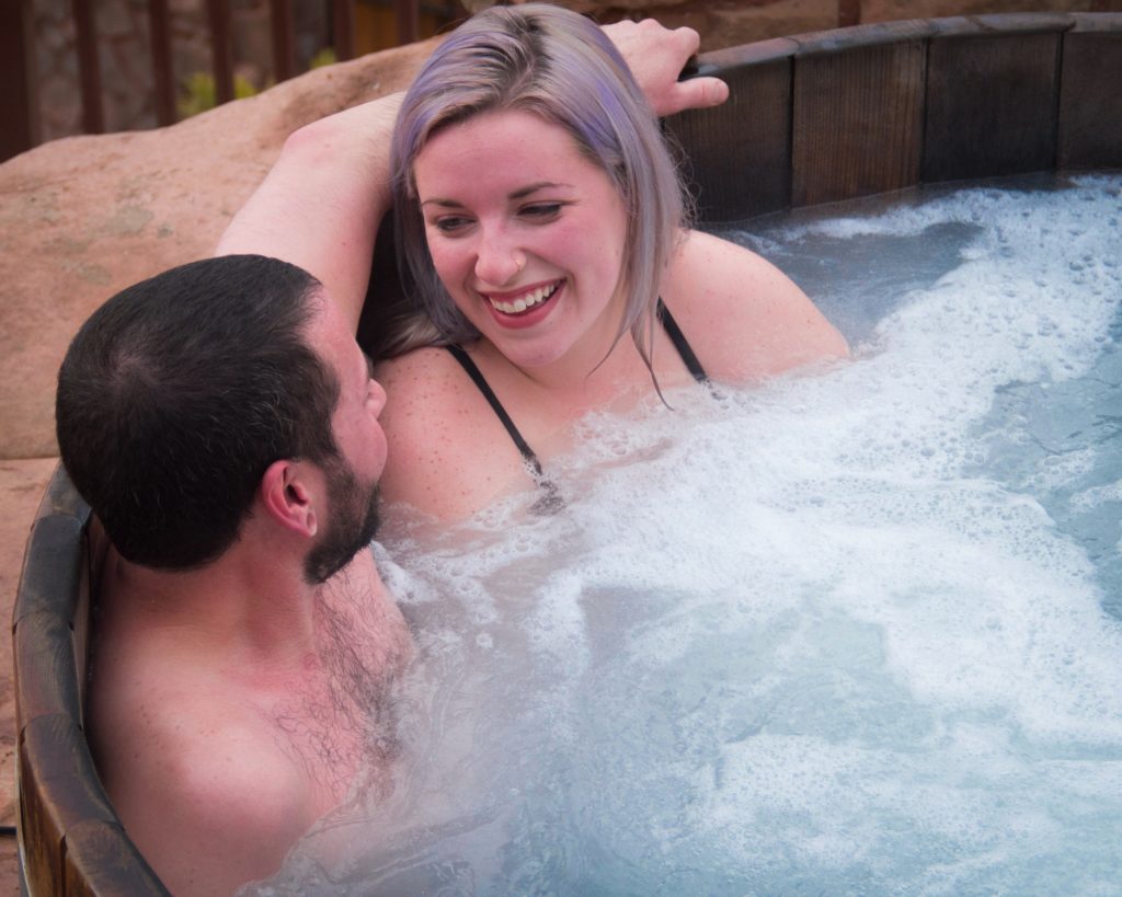 Sunwater Spa - Couple Relaxing in Hot Tub