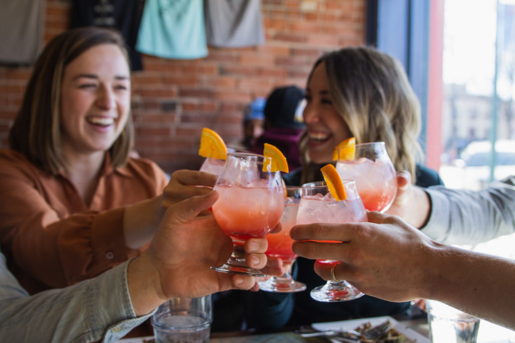 Two Friends Toasting Cocktails on a Food Tour in Downtown Colorado Springs