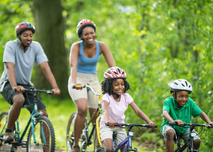 Family Biking on E-Bikes with Helmets in Manitou Springs