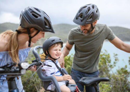 Family with Toddler Son on E-Bike with Helmets