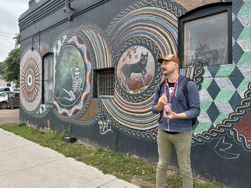 Guide in front of mosaic mural | Denver Graffiti Tour