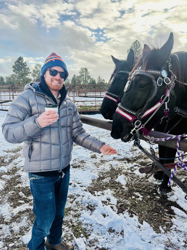 Joel feeding horse in Pagosa Springs